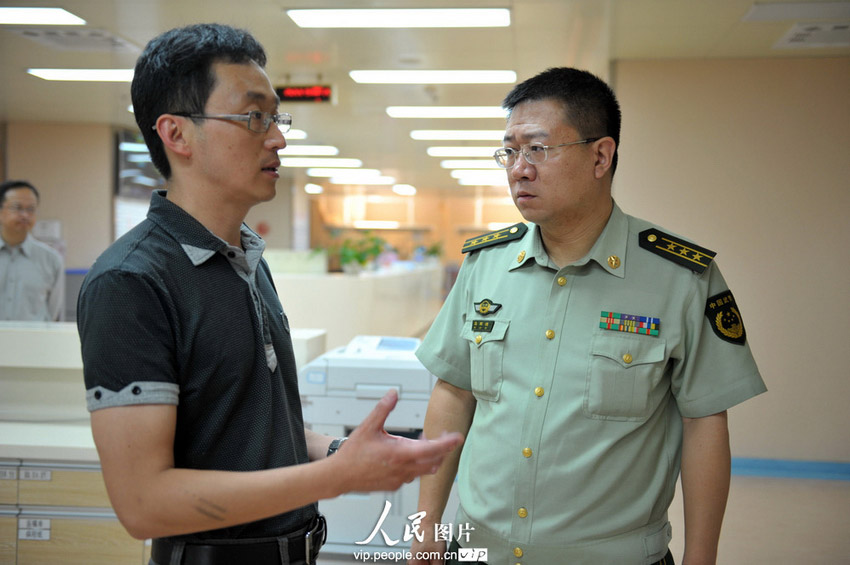 7月17日，武警云南总队医院领导在与云南省第二附属医院领导交谈。(郝亚鑫/人民图片)