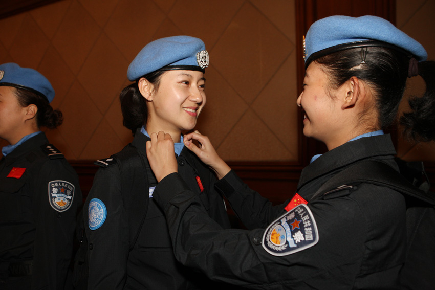 10月21日,两名女维和警察在出发前互相整理服装。新华社发(刘长龙 摄)